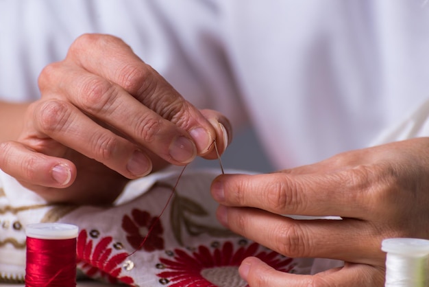 hands with needle and thread